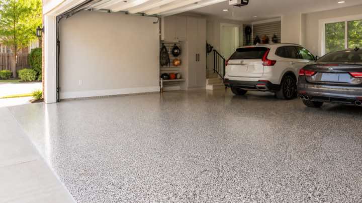 Bright modern garage with a light grey decorative flake floor